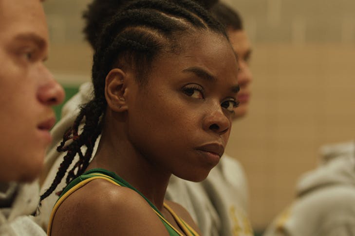 girl wearing basketball jersey on court